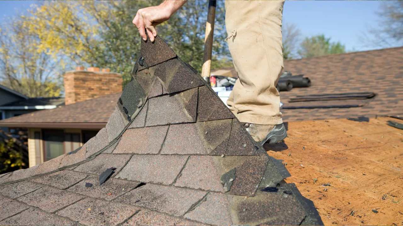 Old roof being repaired - Signs You Need a New Roof